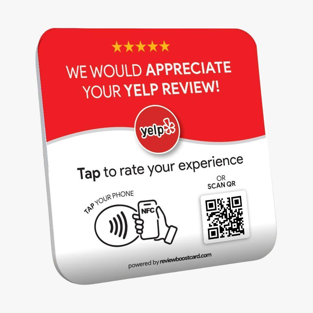 A ReviewBoost plaque requesting Yelp reviews with an NFC tap area and QR code for easy review submission