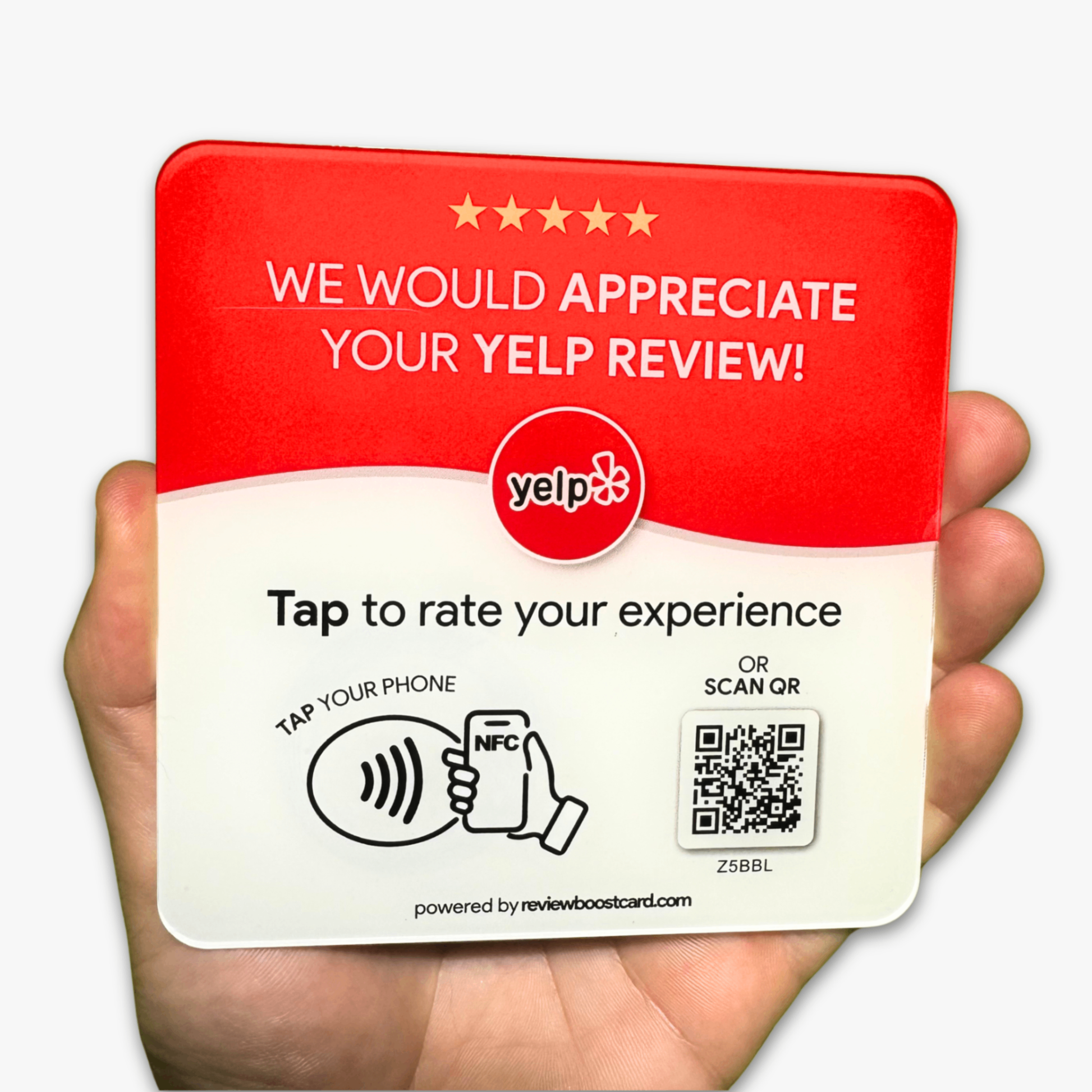 A hand holding an NFC-enabled plaque for Yelp reviews. The plaque features the Yelp logo and a prompt to "Tap to rate your experience" or "Scan QR." A QR code and an NFC symbol are displayed, with instructions on how to use them. The plaque is powered by reviewboostcard.com