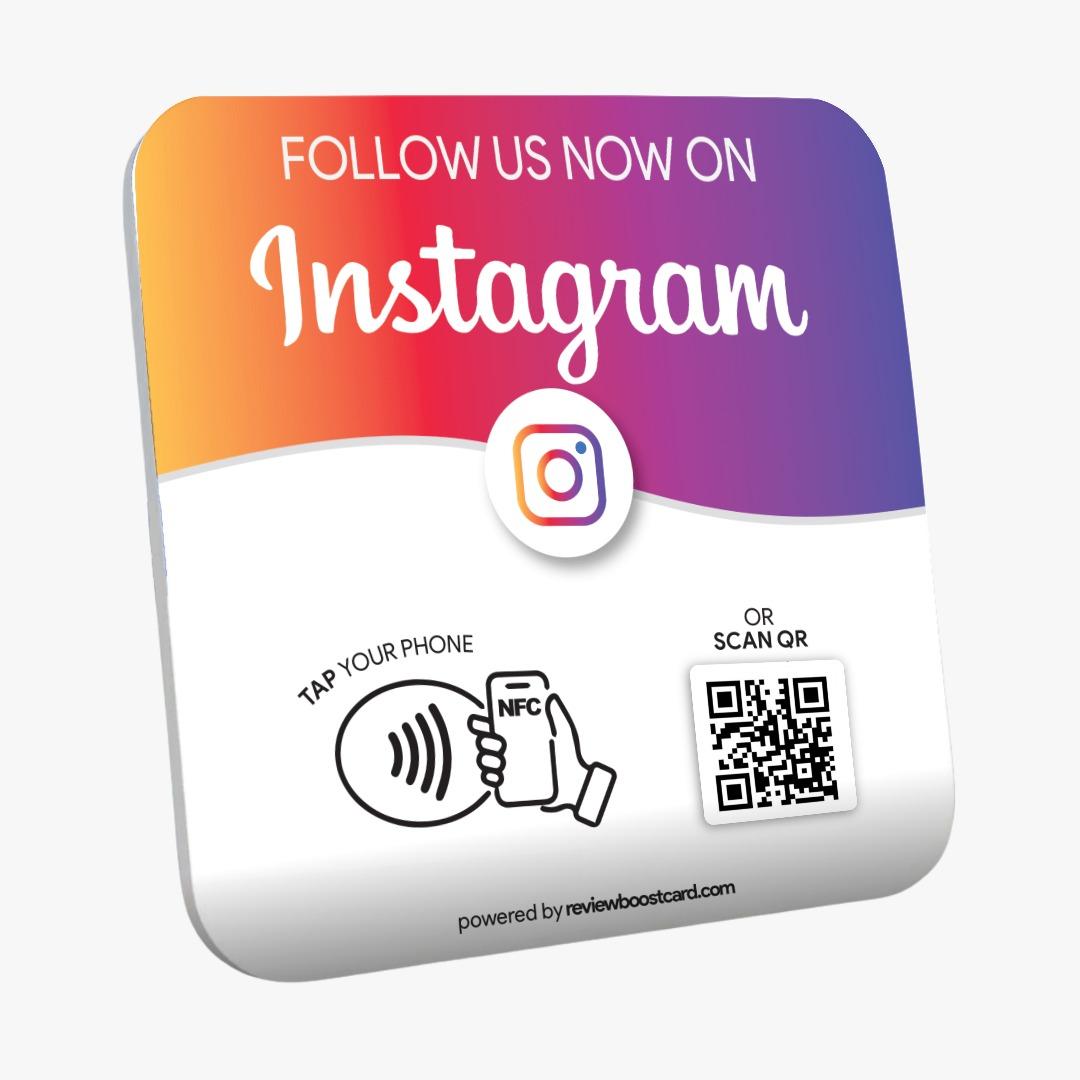 A colorful square plaque with a gradient from orange to purple, featuring the Instagram logo. It has text instructing users to "Follow Us Now on Instagram," with options to "Tap Your Phone" using NFC or "Scan QR" code, powered by reviewboostcard.com